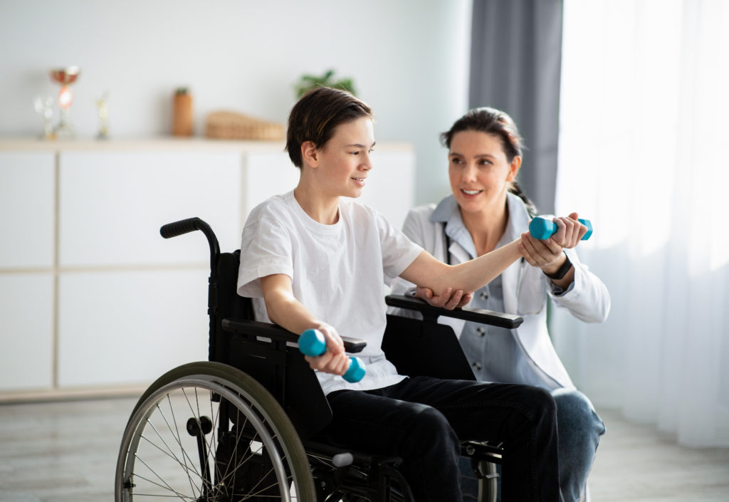 boy in wheelchair doing physical therapy